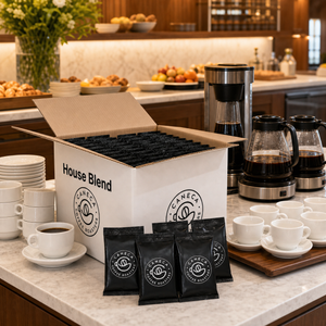 CANECA House Blend case with commercial brewers and guest-ready coffee cups