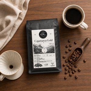 Flat lay of Cajamarca Gold coffee bag with brewing equipment and beans