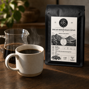Decaf Honduras Copan coffee bag with steaming brewed coffee and glass server