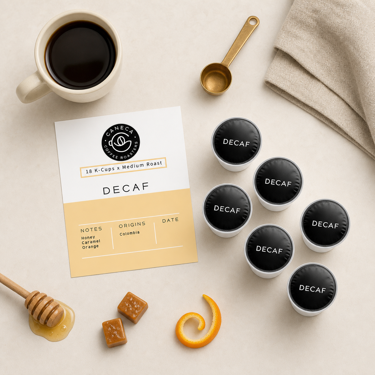 Overhead flat lay of CANECA Decaf K-Cups with honey caramel and orange cues