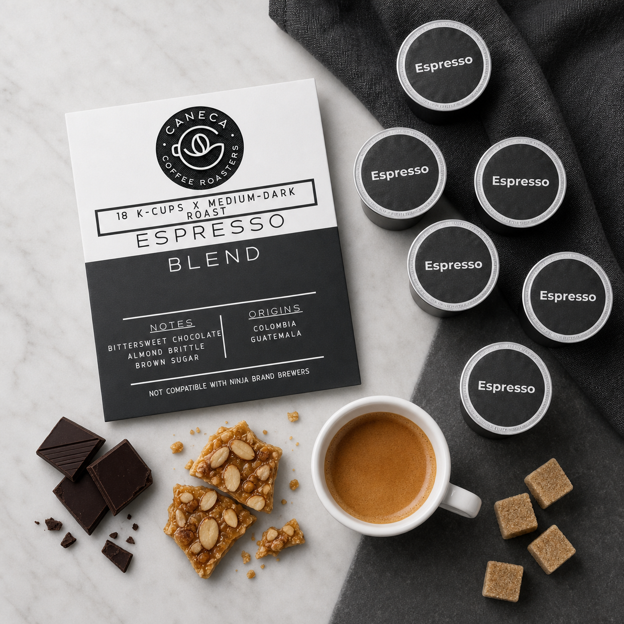 Overhead flat lay of CANECA Espresso K-Cups with chocolate almond brittle and brown sugar