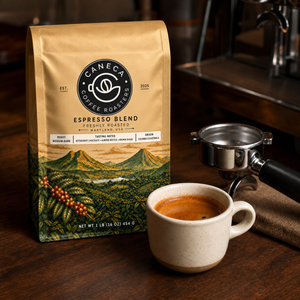 CANECA Espresso Blend new packaging beside freshly brewed espresso
